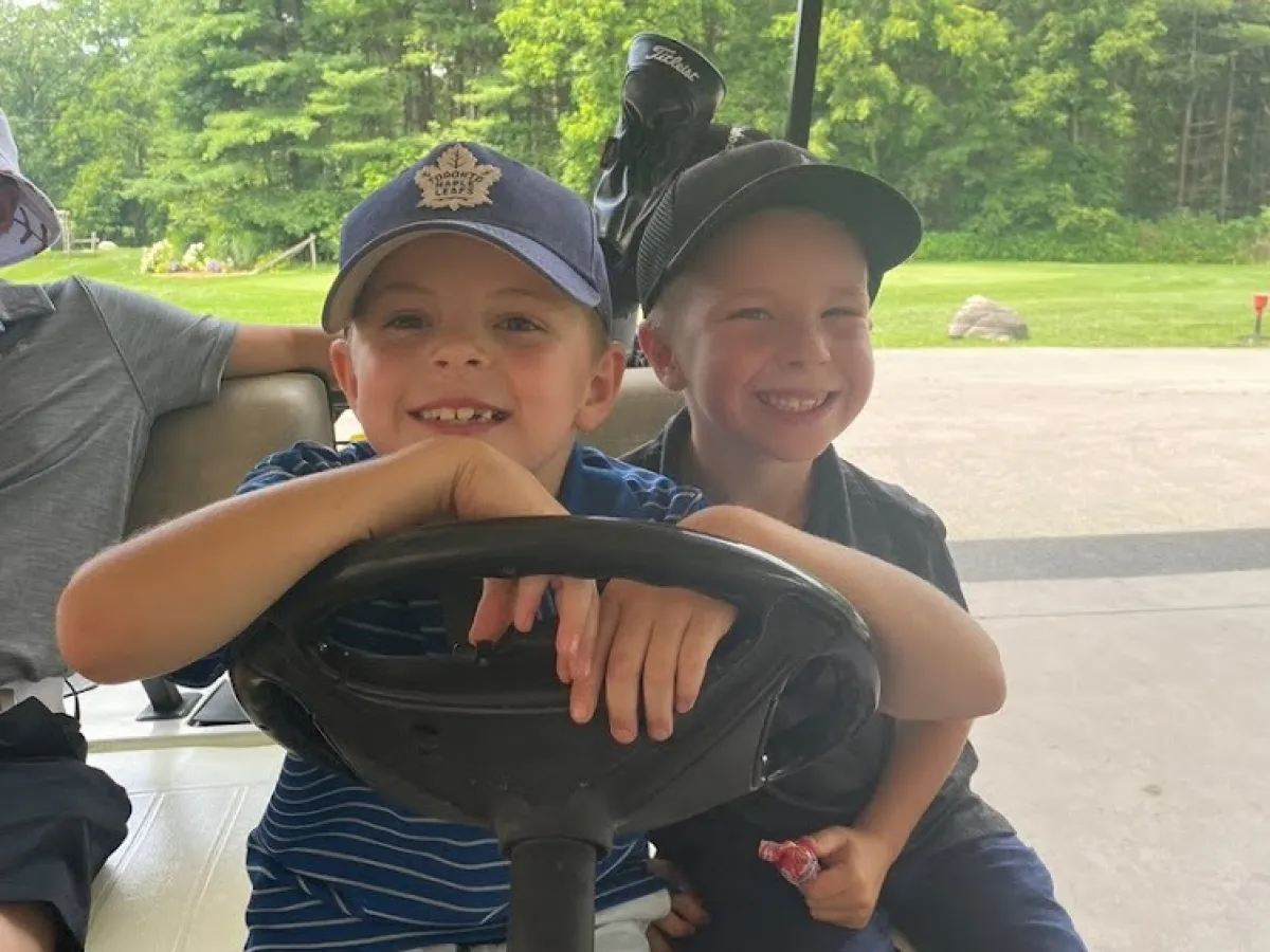 David Nelson et al. sitting around a car