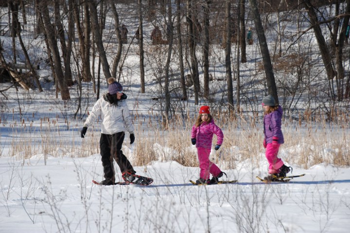 a group of people riding skis down a snow covered slope