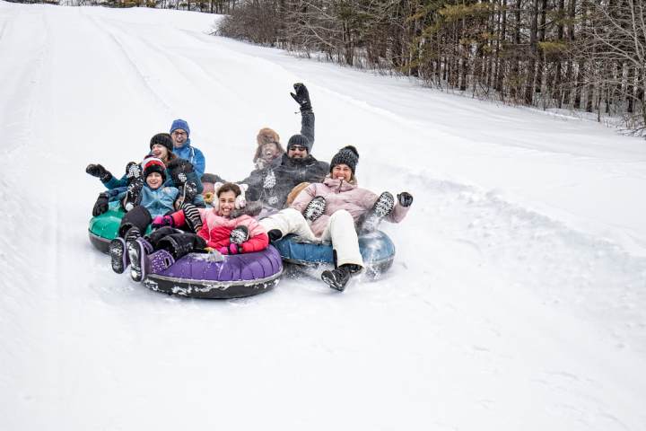 a group of people sitting in the snow
